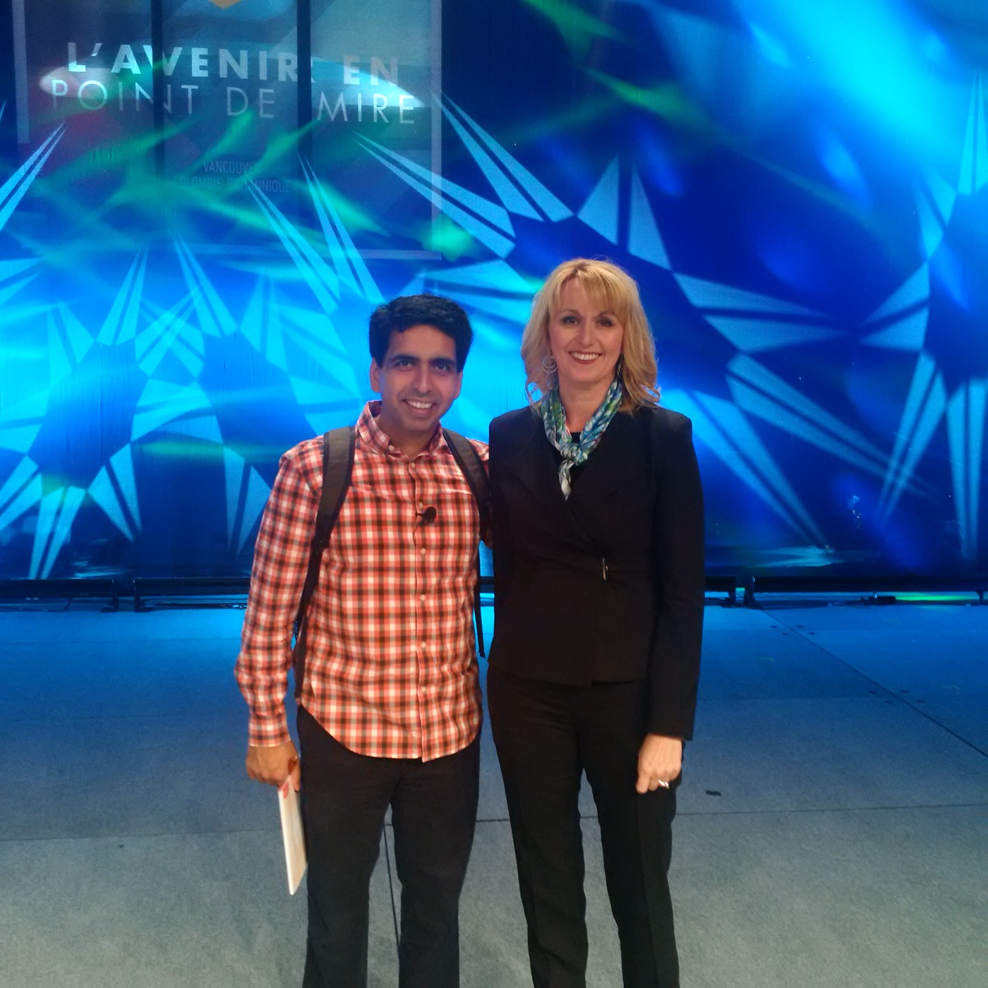 Esther Findlay with a fellow speaker on stage at a conference in Vancouver.